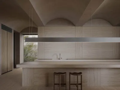Modern minimalist kitchen with concrete walls and a long central island.
