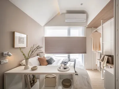 Modern minimalist bedroom featuring wooden furniture, fabric bedding, and metal accents.