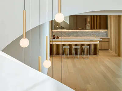 Modern kitchen with wood flooring and vertical wood paneling