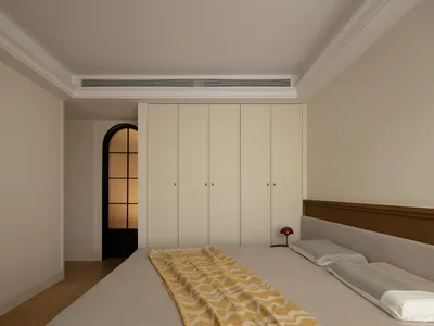 Modern minimalist bedroom with beige walls, wooden bed frame, and a yellow and white striped blanket.