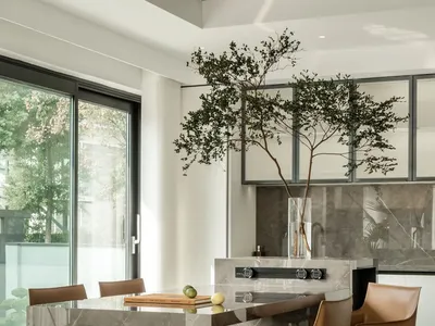 A modern kitchen with marble finishes and a minimalist design.