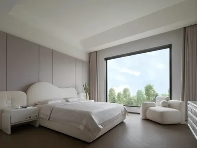 A minimalist bedroom with a large window, fabric blinds, a bed with white bedding, and a white armchair.