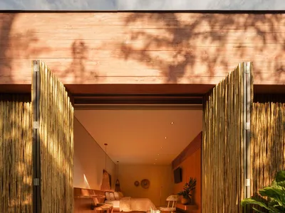 A bohemian-style bedroom with wooden panels made of bamboo.