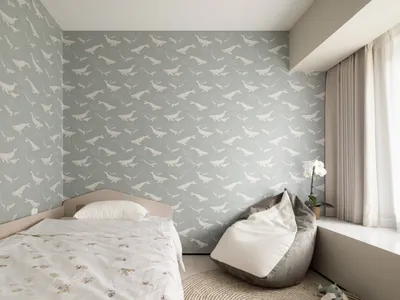 A minimalist bedroom with gray wallpaper featuring whale silhouettes, a bed with white bedding, and a bean bag chair.