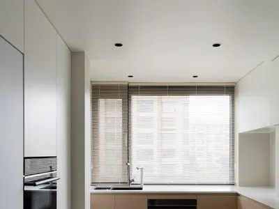 A modern minimalist kitchen with wood and glass materials.