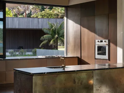 Contemporary kitchen with metallic island and wooden cabinets