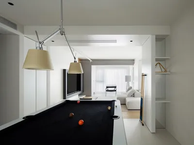 Modern minimalist living room with concrete flooring, metal accents, and sleek furniture.