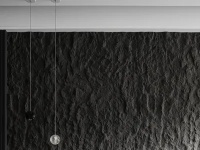 A minimalist bedroom featuring a dark stone accent wall and dark bedding.