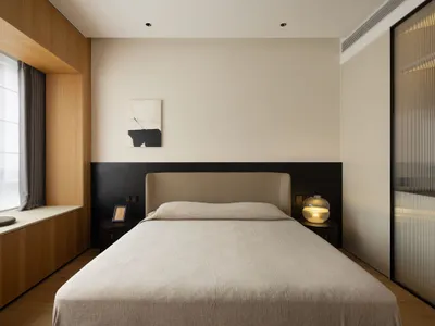 A minimalist bedroom featuring a bed with neutral tones and modern furniture in a neutral color scheme.