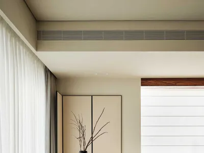 Modern minimalist living room with neutral tones and simple decor.