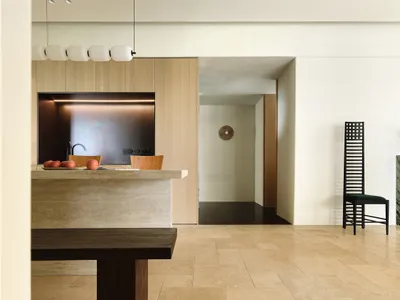 Modern kitchen featuring dark and light natural stone countertops and backsplash, with a minimalist design and sleek lines.