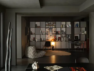 A modern home office with concrete elements and a large dark table.