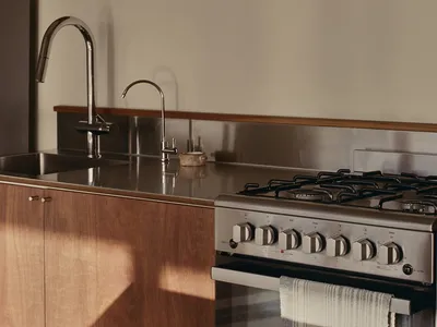 Modern kitchen with metallic accents and stainless steel appliances.