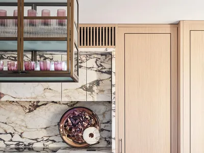 Modern kitchen featuring marble countertops and wooden cabinetry.