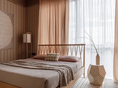 A modern minimalist bedroom with a wooden bed, beige curtains, and a large window.