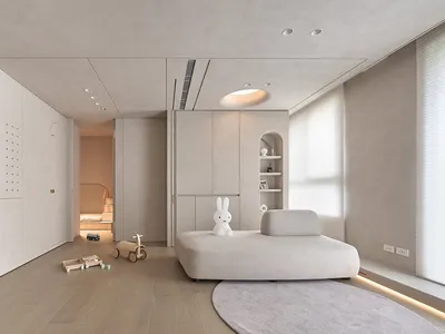 A minimalist bedroom with a fabric seating area, white cabinetry, and modern design elements.