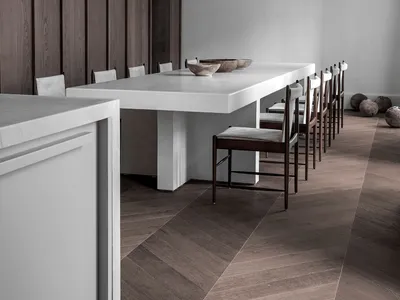 Modern minimalist kitchen with a white concrete table and chairs.