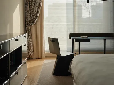 Modern bedroom with neutral colors and minimalist design.