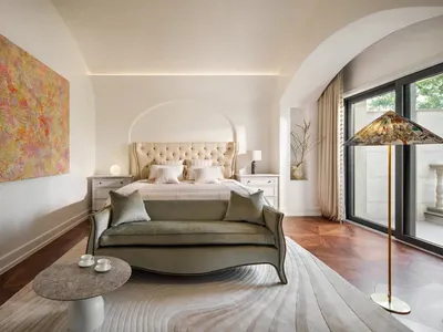 A minimalist bedroom with a modern touch, featuring fabric furniture and a contemporary color palette.