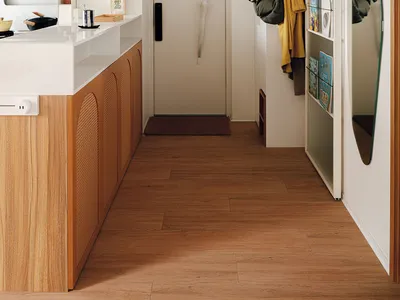A modern kitchen featuring a wooden countertop with white appliances and various kitchenware hanging above.