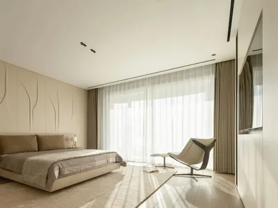 A modern bedroom with neutral-toned textiles and fabrics, highlighting minimalist design elements and a serene, sophisticated