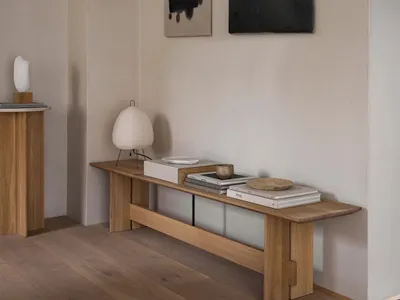 A minimalist living room featuring oak furniture and neutral tones.