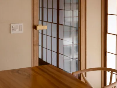 A modern kitchen with a wooden frame and glass door.