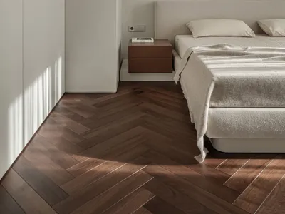 A minimalist bedroom with a bed, floating nightstand, and simple decor in neutral tones.
