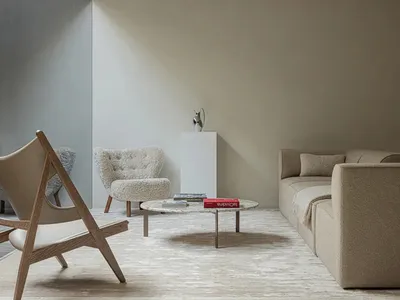 A minimalist industrial living room with a modern sofa, armchair, and coffee table.