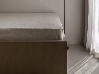 Minimalist bedroom with a bed, curtain, and floor lamp