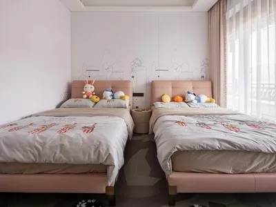 comfortable twin beds with light-colored fabric headboards in a modern bedroom setting