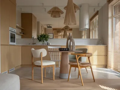 Modern, minimalist residential kitchen featuring wooden cabinets and flooring.
