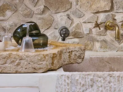 Modern kitchen featuring a stone countertop and brass fixtures.