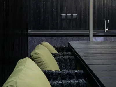 An industrial-style outdoor lounge area featuring metal and wood elements.