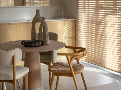Modern kitchen with woven chairs and wooden furniture