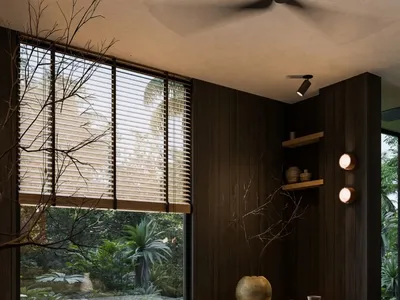 A modern minimalist bedroom featuring wooden furnishings and a glass window overlooking a lush garden.