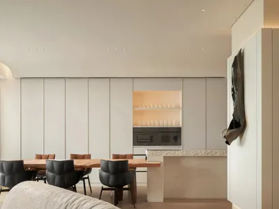 A modern kitchen featuring a wooden dining table, metal chairs, and stone countertops.