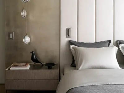 A minimalist bedroom with neutral tones and modern decor.