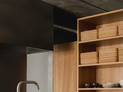 Modern kitchen featuring wooden cabinets and stainless steel hardware.
