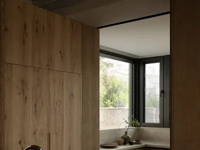 Modern residential kitchen with wooden cabinets and black countertop sink