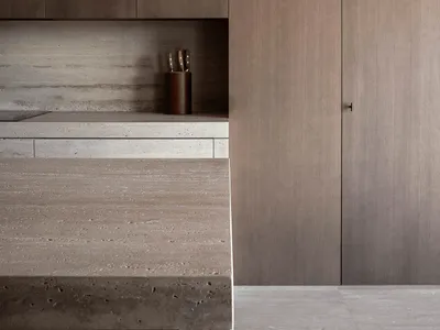 Modern, minimalist kitchen featuring concrete countertops and backsplash.