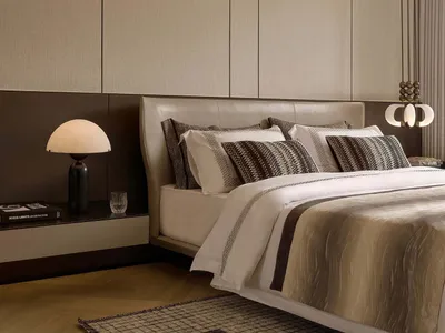 Modern minimalist bedroom with wooden floor, upholstered bed, fabric headboard, and glass pendant light.