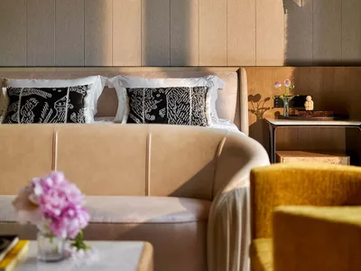 Modern bedroom featuring plush fabric upholstery and sleek, contemporary furnishings.