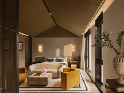 Modern minimalist bedroom with wooden walls and glass walls, featuring a white bed with black and white pillows, yellow armch