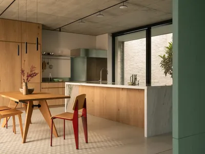 Modern minimalist kitchen featuring wood, marble, concrete, and brass materials.