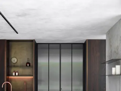 Modern kitchen featuring stone countertops and metal accents.