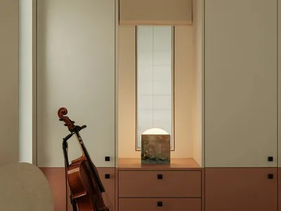 A minimalist bedroom with a white and brown cabinet, a basin, and a cello leaning against the wall.