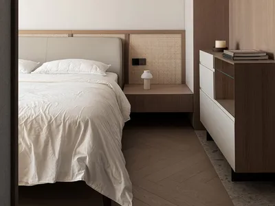A minimalist bedroom featuring textured wood, woven cane, and soft textiles.