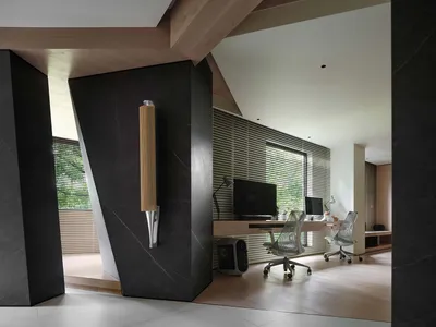 A modern home office featuring dark wooden panels and minimalist design.