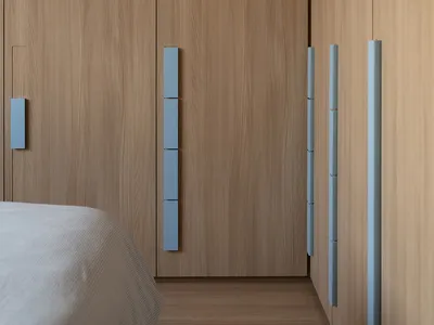 A modern minimalist bedroom featuring wooden furniture and paneling.